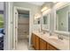 Bathroom features double vanity, tile floors, a mirror, and bath/shower combo at 9880 Montclair Cir, Apopka, FL 32703
