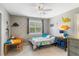 Cozy ' bedroom with carpet, ceiling fan, shuttered window, and dinosaur decorations at 9880 Montclair Cir, Apopka, FL 32703