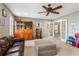 A spacious bonus room with carpet, a ceiling fan, and plenty of room to spread out at 9880 Montclair Cir, Apopka, FL 32703