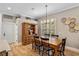 Cozy dining room featuring wood floors, a wooden cabinet, and natural light at 9880 Montclair Cir, Apopka, FL 32703