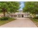 Charming home featuring a brick driveway, three-car garage, and manicured landscaping at 9880 Montclair Cir, Apopka, FL 32703