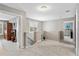 Upstairs hallway with neutral walls, carpet, and natural light leads to bedrooms and stairway at 9880 Montclair Cir, Apopka, FL 32703