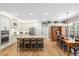 Open kitchen with large island and seating, flowing into a dining area with a wooden table at 9880 Montclair Cir, Apopka, FL 32703