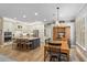 Spacious kitchen and dining area with a central island, wood floors, and modern appliances at 9880 Montclair Cir, Apopka, FL 32703