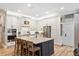 Well-lit kitchen featuring white cabinetry, a central island with seating, and modern appliances at 9880 Montclair Cir, Apopka, FL 32703