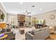 Bright living room with a stone fireplace, comfortable seating, and view to the backyard at 9880 Montclair Cir, Apopka, FL 32703