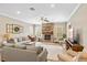 Inviting living room with stone fireplace, wood floors, and abundant natural light at 9880 Montclair Cir, Apopka, FL 32703
