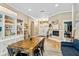 Open concept living and dining area with bookshelves and a view of the entryway at 9880 Montclair Cir, Apopka, FL 32703