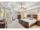 Elegant main bedroom with tray ceiling, plantation shutters, and ample closet space at 9880 Montclair Cir, Apopka, FL 32703