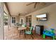 Inviting covered patio featuring brick flooring and a mounted TV at 9880 Montclair Cir, Apopka, FL 32703