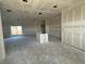 Spacious living room showcasing a kitchen island and sliding glass doors at 10 Juniper Loop Ter, Ocala, FL 34480
