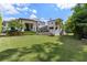Expansive lawn featuring mature landscaping and a view of the rear elevation at 10138 Enchanted Oak Dr, Golden Oak, FL 32836