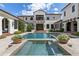A stunning backyard view of the pool, patio, and architectural design of this exceptional property at 10138 Enchanted Oak Dr, Golden Oak, FL 32836