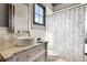 Bright bathroom featuring vessel sink, marble countertop, decorative mirror, and shower with curtain at 10138 Enchanted Oak Dr, Golden Oak, FL 32836
