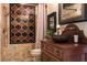 Unique bathroom featuring a decorative tile shower, wood vanity, and rustic fixtures for a warm aesthetic at 10138 Enchanted Oak Dr, Golden Oak, FL 32836