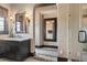 Elegant bathroom featuring dark wood vanity, marble countertop, framed mirrors and a glass shower at 10138 Enchanted Oak Dr, Golden Oak, FL 32836