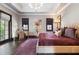 Spacious bedroom with a chandelier, a decorative rug, two windows and a vanity desk at 10138 Enchanted Oak Dr, Golden Oak, FL 32836