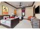 Spacious bedroom with two beds, Mickey Mouse decor, a ceiling fan, and stylish furnishings at 10138 Enchanted Oak Dr, Golden Oak, FL 32836