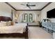Beautiful bedroom with window seat, custom sconces, and stylish decor for a relaxing and inviting space at 10138 Enchanted Oak Dr, Golden Oak, FL 32836