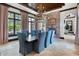 Formal dining room with wood ceiling, large windows, and chandelier, featuring seating for eight people at 10138 Enchanted Oak Dr, Golden Oak, FL 32836