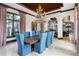 Formal dining room features wood table, seating for eight, unique chandelier, and built-in mirrored accent wall at 10138 Enchanted Oak Dr, Golden Oak, FL 32836