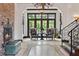 Elegant foyer with a fireplace, beautiful tile flooring, staircase and large windows offering natural light and views at 10138 Enchanted Oak Dr, Golden Oak, FL 32836