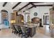 Spacious kitchen with granite island, beamed ceilings, and modern stainless steel appliances at 10138 Enchanted Oak Dr, Golden Oak, FL 32836