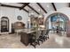 Open kitchen with a large island, beamed ceilings, and seamless flow to the dining area at 10138 Enchanted Oak Dr, Golden Oak, FL 32836