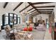 Open-concept living room boasts beamed ceilings, neutral tones, and a seamless flow to the kitchen area at 10138 Enchanted Oak Dr, Golden Oak, FL 32836