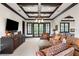Open-concept living room with high ceilings, comfortable seating, and balcony access at 10138 Enchanted Oak Dr, Golden Oak, FL 32836