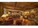 Sophisticated lounge area with a full bar, leather seating, a fireplace, and an inviting atmosphere at 10138 Enchanted Oak Dr, Golden Oak, FL 32836