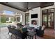 Relaxing outdoor living room with a fireplace, comfortable seating, and views of the pool area at 10138 Enchanted Oak Dr, Golden Oak, FL 32836