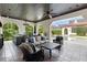 Inviting outdoor living area with a full kitchen, comfortable seating and views of the sparkling pool and lush landscaping at 10138 Enchanted Oak Dr, Golden Oak, FL 32836