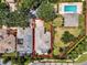 Overhead view of the property highlighting the home, community pool, landscaping, and surrounding area at 10662 Woodchase Cir, Orlando, FL 32836