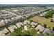 High-angle aerial view of the home, located near lakes, green spaces, and community amenities at 10662 Woodchase Cir, Orlando, FL 32836