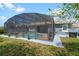 Backyard featuring a screened in pool, dining area, and grill at 10662 Woodchase Cir, Orlando, FL 32836