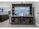 Bar area with custom cabinetry, wine racks, glass storage, and display lighting at 10662 Woodchase Cir, Orlando, FL 32836