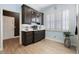 Wet bar with cabinetry, countertop, undermount refrigerator, and window with wooden shutters at 10662 Woodchase Cir, Orlando, FL 32836