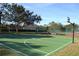 Outdoor basketball court with well-maintained surface and hoops, surrounded by trees at 10662 Woodchase Cir, Orlando, FL 32836