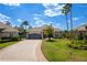 Charming single-story home with manicured lawn, palm trees, and a brick-paved driveway at 10662 Woodchase Cir, Orlando, FL 32836