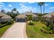 Charming single-story home with a paver driveway, well-manicured lawn, and a beautiful palm tree at 10662 Woodchase Cir, Orlando, FL 32836