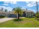 Charming single-Gathering home boasts a well-manicured lawn and lovely landscaping, including a palm tree at 10662 Woodchase Cir, Orlando, FL 32836