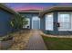 Inviting front entrance with a stone pathway, lush landscaping, and a charming blue-painted facade at 10662 Woodchase Cir, Orlando, FL 32836