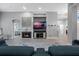 Bright living room with fireplace, TV, modern furnishings, and an open doorway leading to the main bedroom at 10662 Woodchase Cir, Orlando, FL 32836