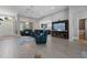 Open-concept living room features tile floors, comfortable seating, bar area, and natural light at 10662 Woodchase Cir, Orlando, FL 32836