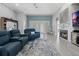 Spacious living room features modern furniture, a fireplace, and an open view to the kitchen at 10662 Woodchase Cir, Orlando, FL 32836