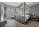 The main bedroom features a four-poster bed, neutral color palette, and shuttered windows at 10662 Woodchase Cir, Orlando, FL 32836