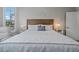 Comfortable bedroom with a decorative headboard, complemented by stylish bedside tables with lamps at 10662 Woodchase Cir, Orlando, FL 32836