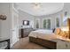 Spacious bedroom featuring a ceiling fan, wood floors, and a dresser beneath a wall-mounted TV at 10662 Woodchase Cir, Orlando, FL 32836