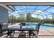 Relaxing screened patio with outdoor dining area next to pool at 10662 Woodchase Cir, Orlando, FL 32836